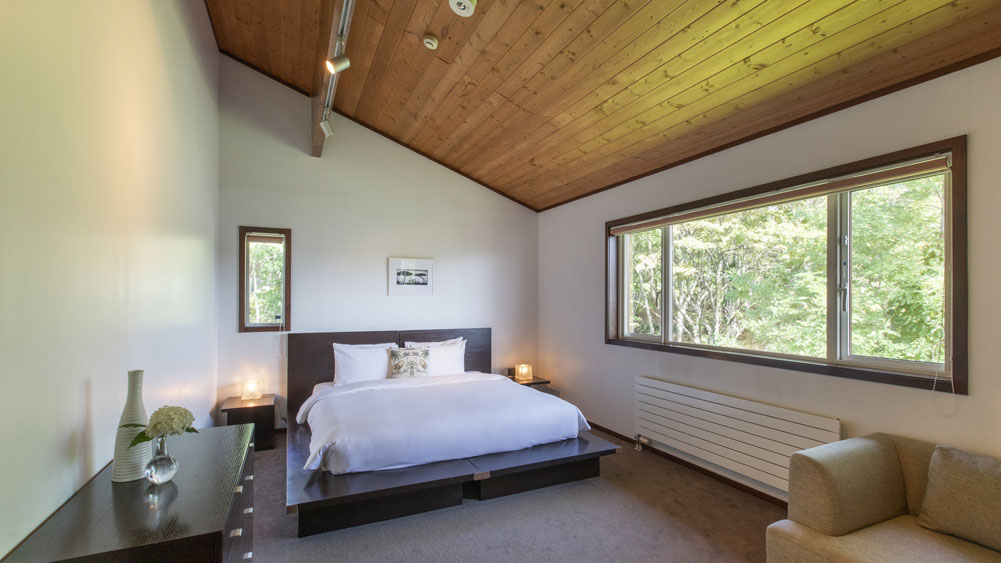 Casa La Mount  - Restful guest bedroom with a forest view